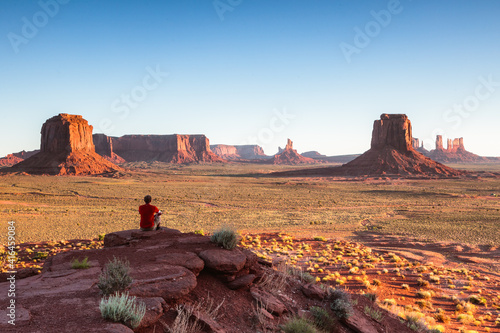 Man looking at Moument valley at sunrise, USA photo