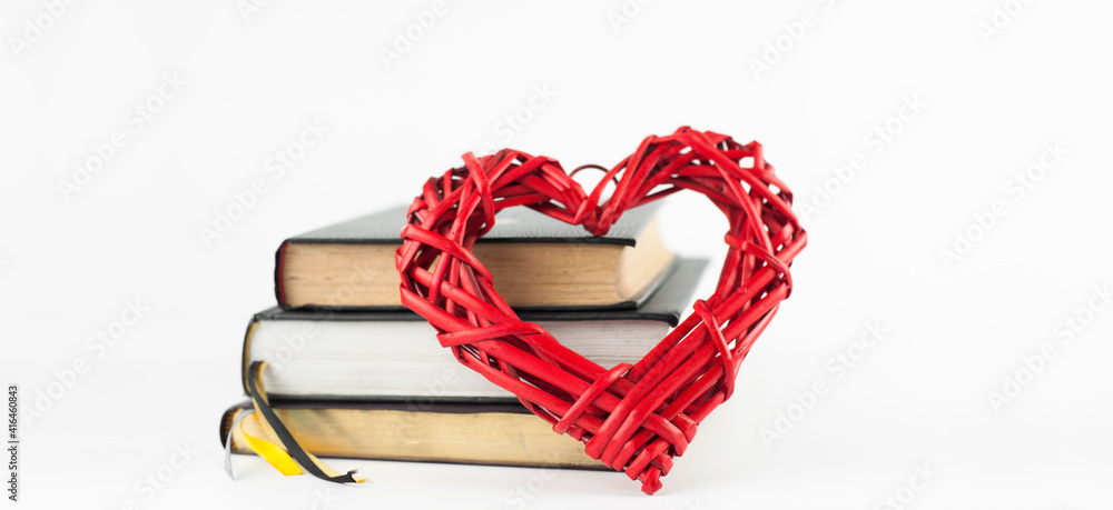 Stack of books on a white background. Red heart. Isolated Stack of books on a white background. Red heart. Isolated