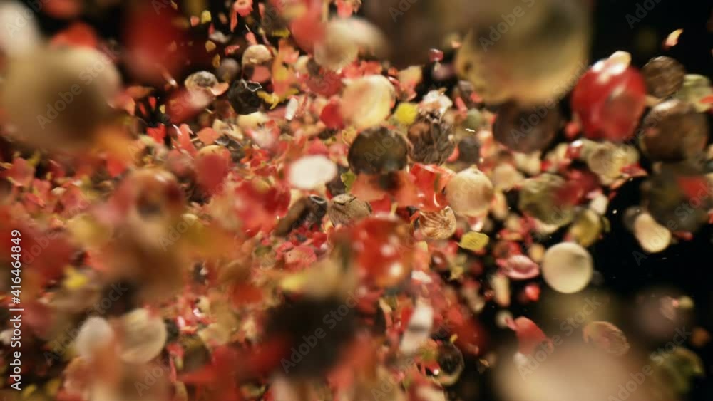 Super slow motion of falling whole colored pepper spice on black background. Filmed on high speed camera, 1000 fps
Super slow motion of falling whole colored pepper spice on black background. Filmed on high speed camera, 1000 fps