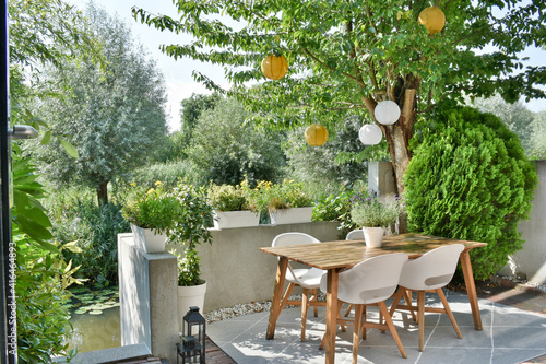 Foto Beautiful backyard terrace full of furniture and decorative plants