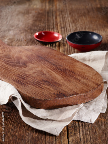 wood cutting board and utensils on wooden table