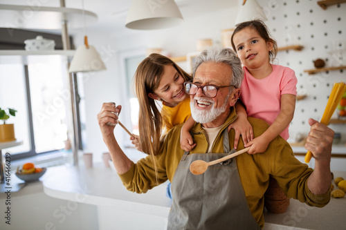 Happy grandparents having fun times with children at home