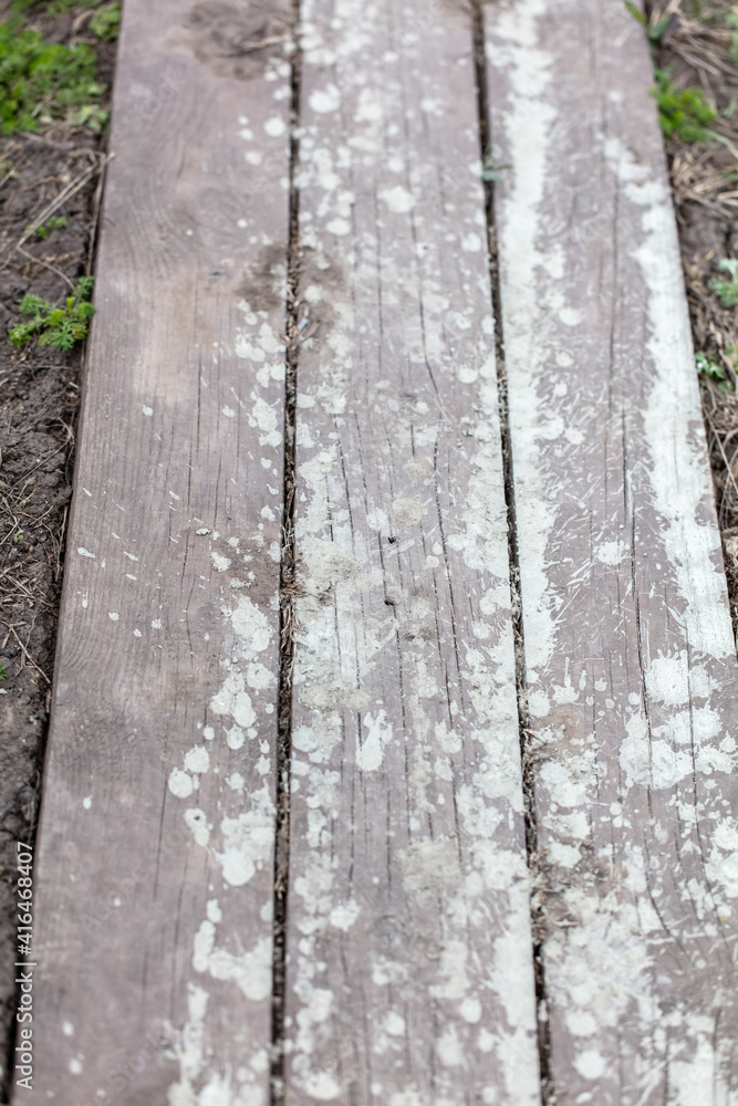Drops and splashes from concrete on a wooden board Drops and splashes from concrete on a wooden board