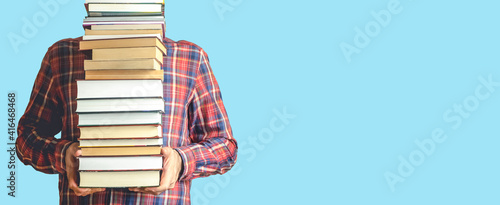 Tableau sur toile Student with books on a blank colored banner background
