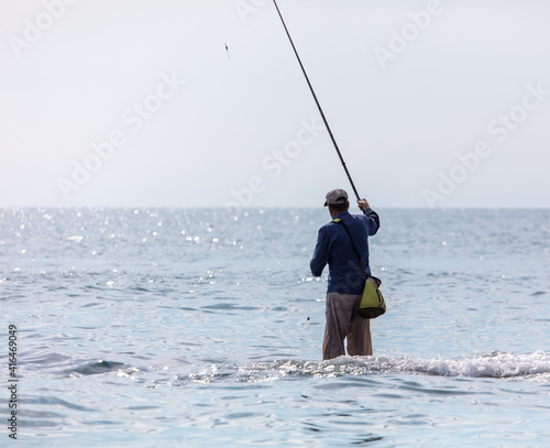 A man with a fishing rod is fishing