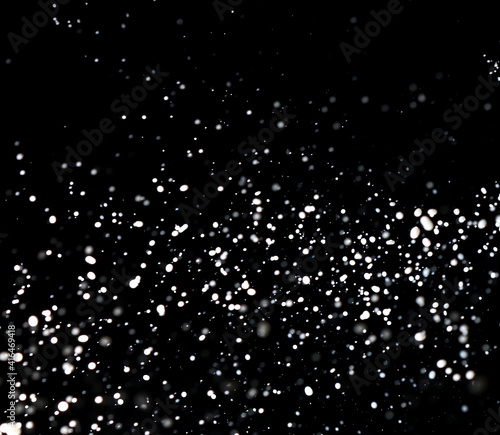 Splashes of white milk isolated on a black background. © schankz