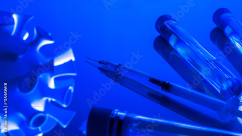 Medical equipment. Medical syringe with needle for protection flu virus and coronavirus. Covid vaccine on blue. Disease care hospital prevention.