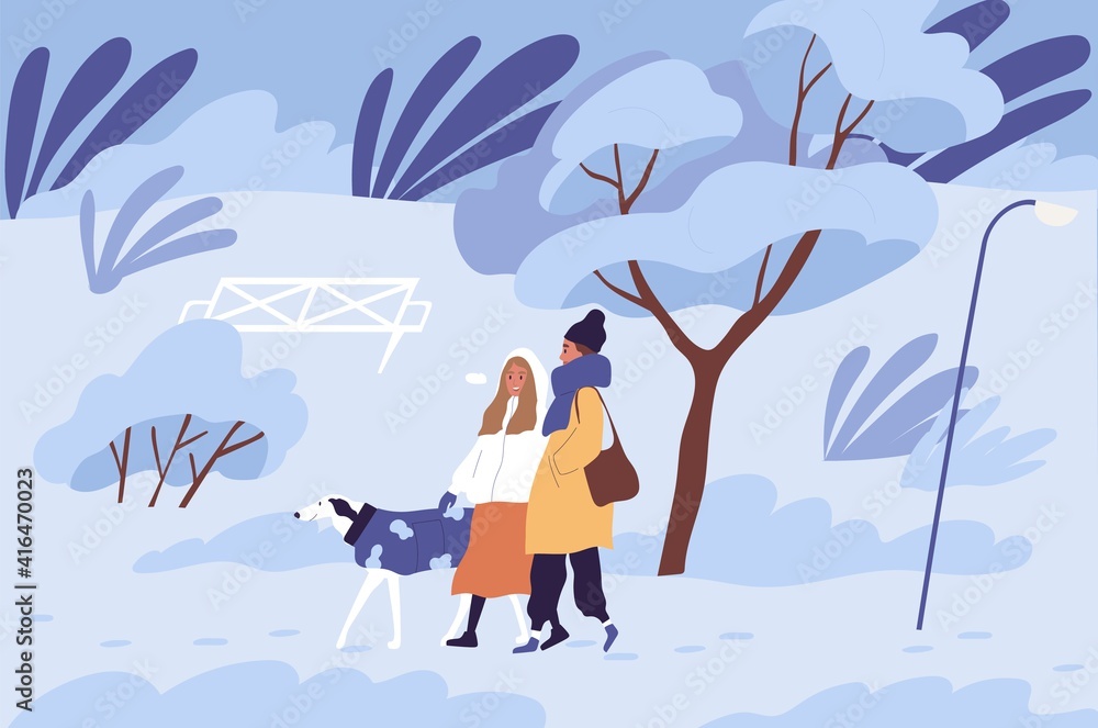Couple of people walking with dog in winter park in cold freezing ...