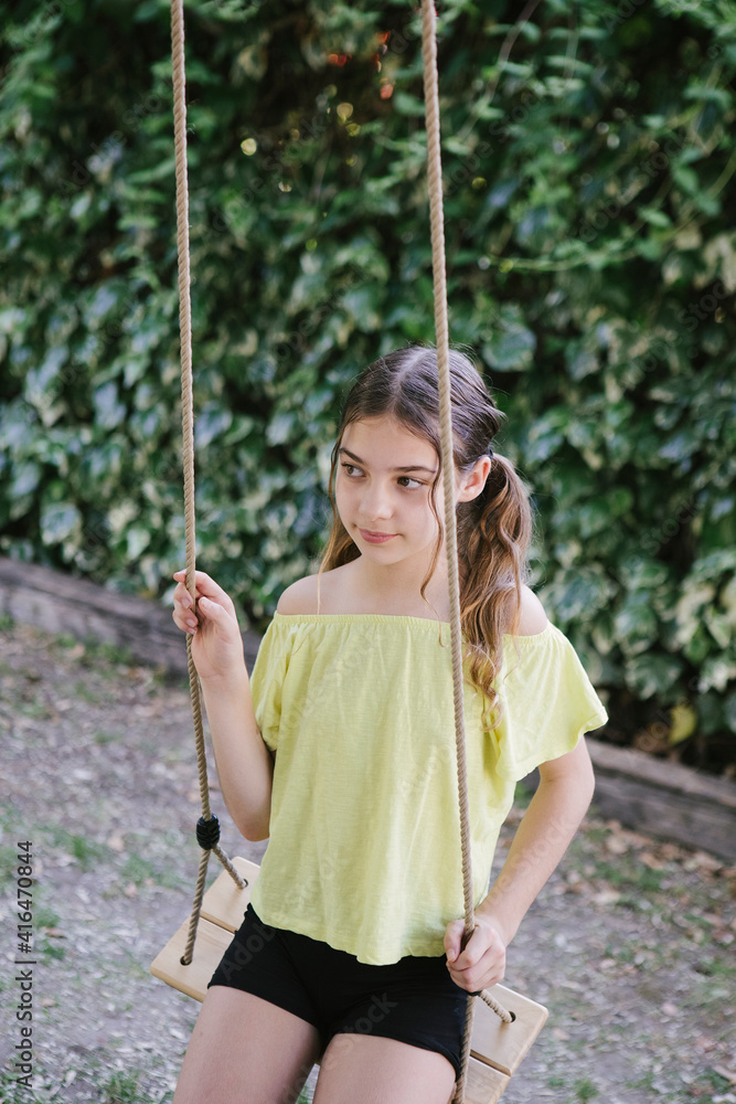 Little girl on a swing in park