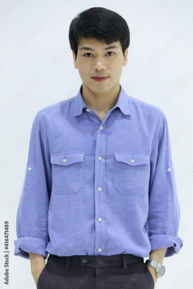 Handsome smiling Asian business man in blue shirt standing with Pick pocket pants arms, on white background. Concept business woman manager. Handsome smiling Asian business man in blue shirt standing with Pick pocket pants arms, on white background. Concept business woman manager.