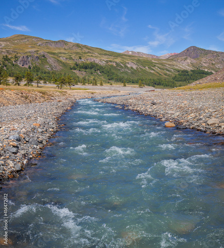 Clear mountain river on a summer day, blue sky