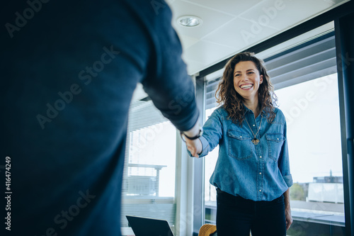 Businesswoman shaking hands with a job applicant photo