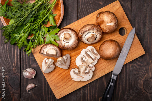 sliced mushrooms on a chopping board with herbs
