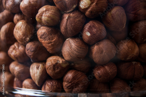 Closeup on hazel nuts in glass container