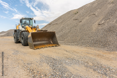 Excavator at a construction site in the extraction of stone and rock