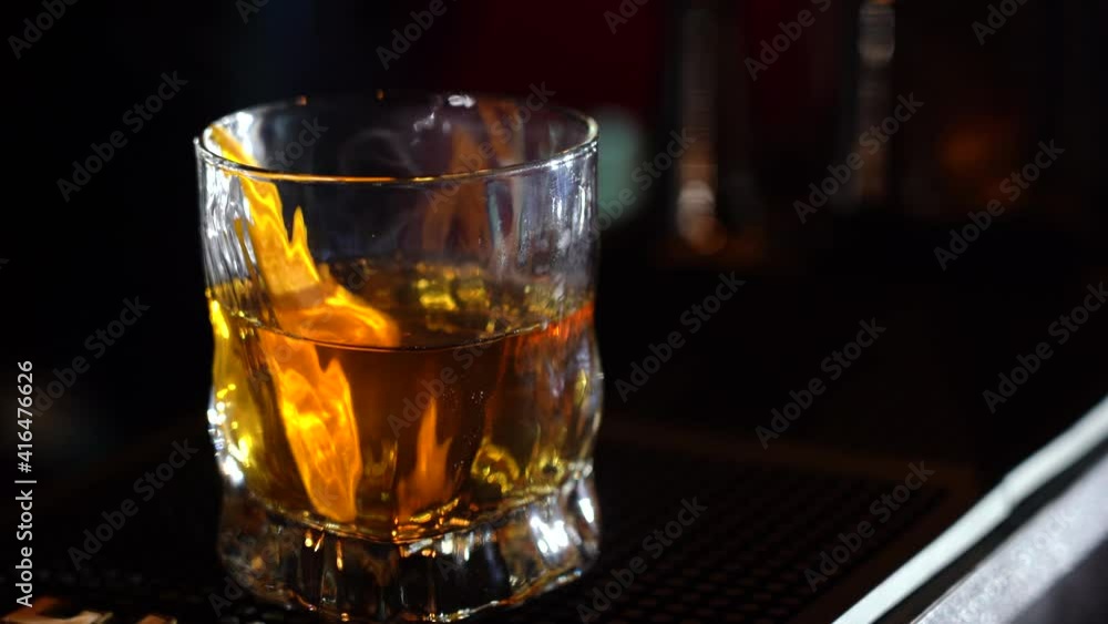 glass of whiskey with ice and smoke on bar glass of whiskey with ice and smoke on bar
