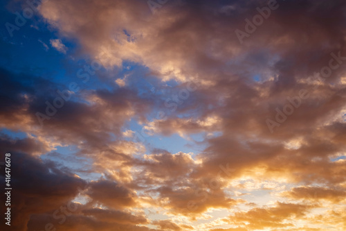 Calm sea with sunset sky and sun through the clouds over.