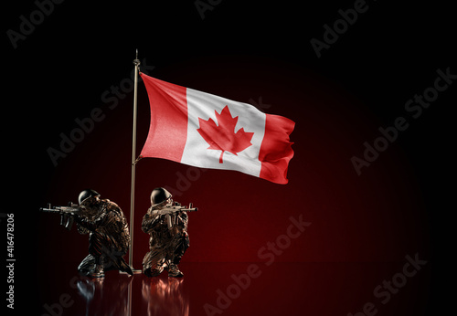 Concept of military conflict. Waving national flag of Canada. Two soldier statue guards defending the symbol of country against red wall