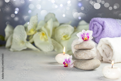 Spa resort therapy composition. Stones  burning candles  towel  abstract lights