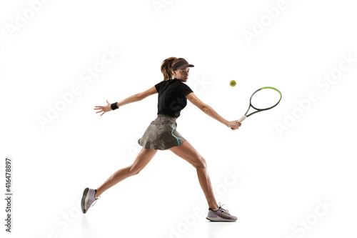 Speed. Young caucasian professional sportswoman playing tennis isolated on white background. Training, practicing in motion, action. Power and energy. Movement, ad, sport, healthy lifestyle concept. © master1305