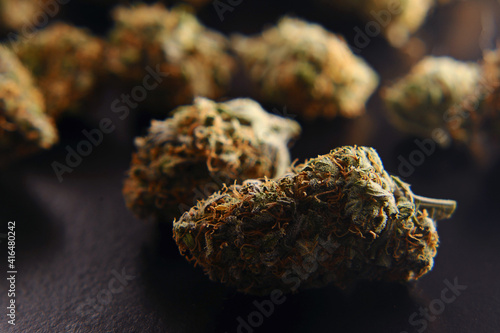Marijuana buds closeup. Medicinal cannabis on black background. Hemp recreation, medical usage, legalization.