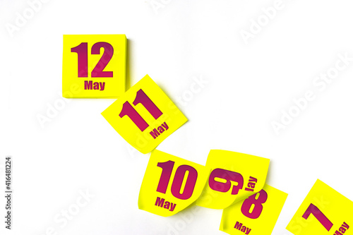 May 12nd. Day 12 of month, Calendar date. Many yellow sheet of the calendar. Spring month, day of the year concept. photo