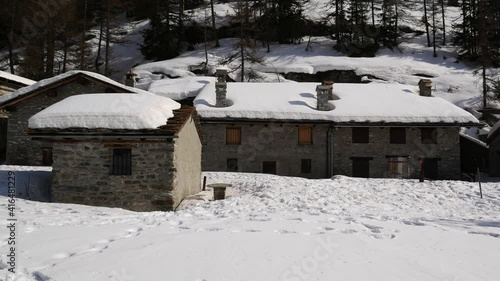 Wallpaper Mural Panoramic view of a small mountain village in a snow-covered field. Sunny day. Italian Alps, Aosta Valley, Italy. Torontodigital.ca