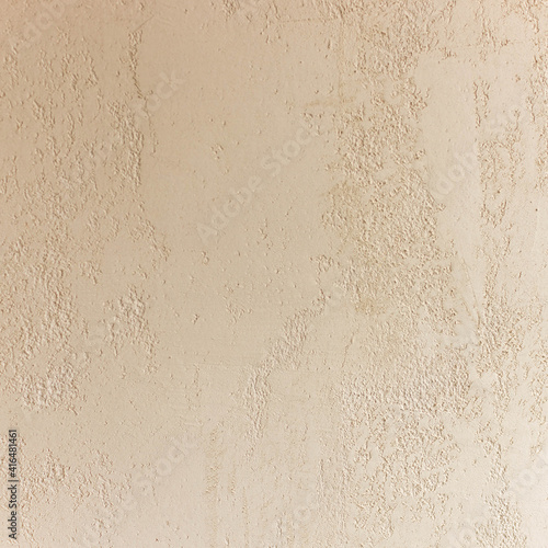 Beige matt plaster wall close up. Decorative Venetian plaster wall
