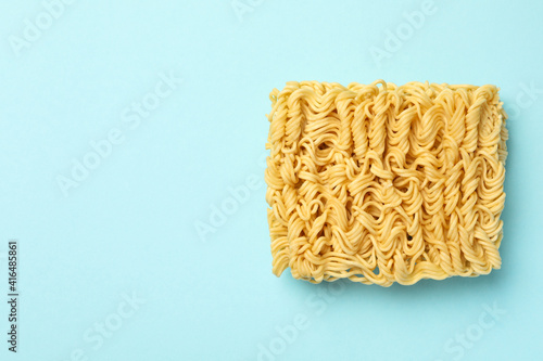 Piece of instant noodles on blue background