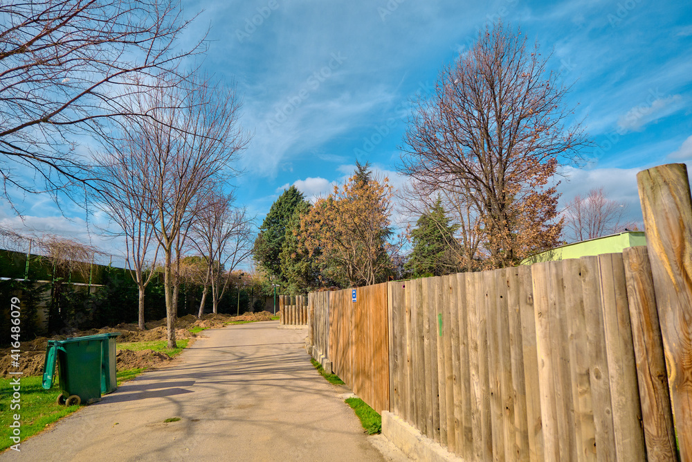 Wooden tree bodies for fences and walking path and way in zoo park made of gravel road. Wooden tree bodies for fences and walking path and way in zoo park made of gravel road.