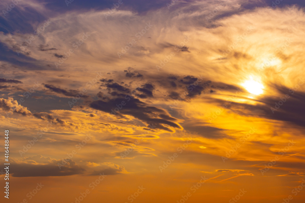 Sunset sky with feather clouds, rich color nature. Background for design