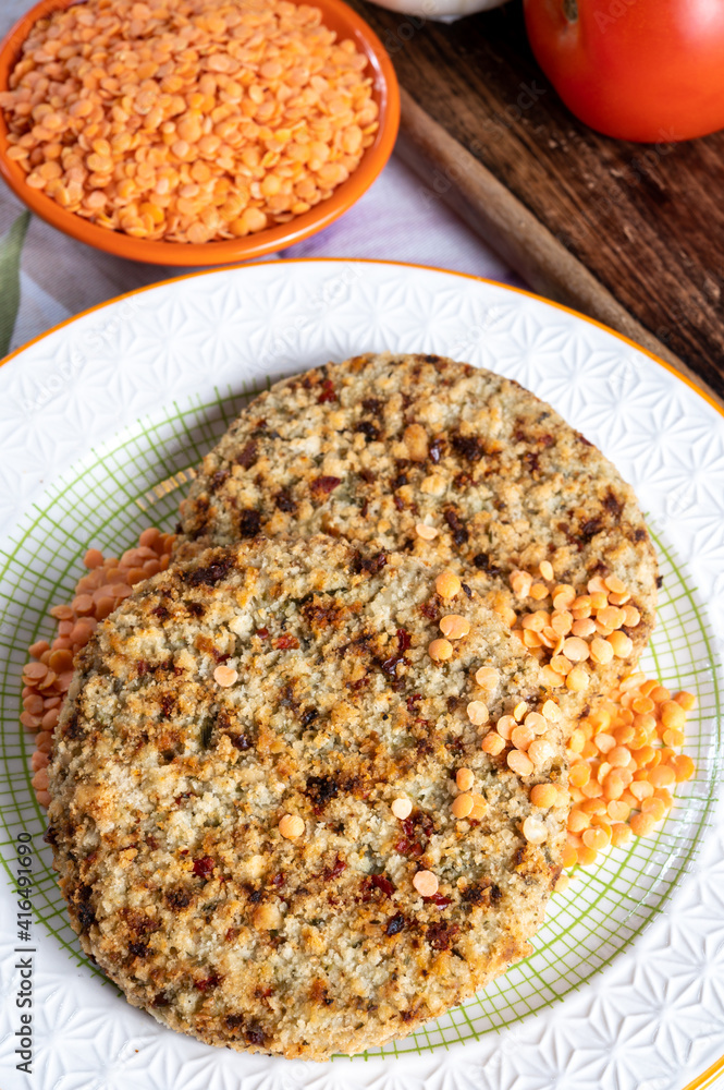 Tasty vegetarian food, burgers made from orange lentils legumes with sun dried tomatoes Tasty vegetarian food, burgers made from orange lentils legumes with sun dried tomatoes