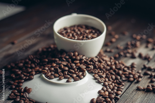 white cup and saucer coffee beans on a wooden background aroma drink