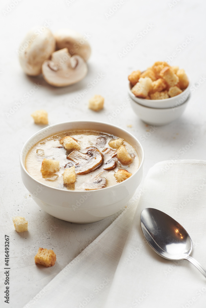 Tasty mushrooms soup with croutons on a white table. Healthy diet concept. Tasty mushrooms soup with croutons on a white table. Healthy diet concept.