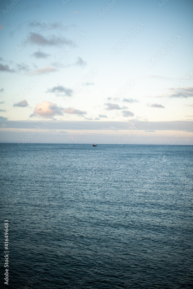 Single boat seen in ocean with clear sky