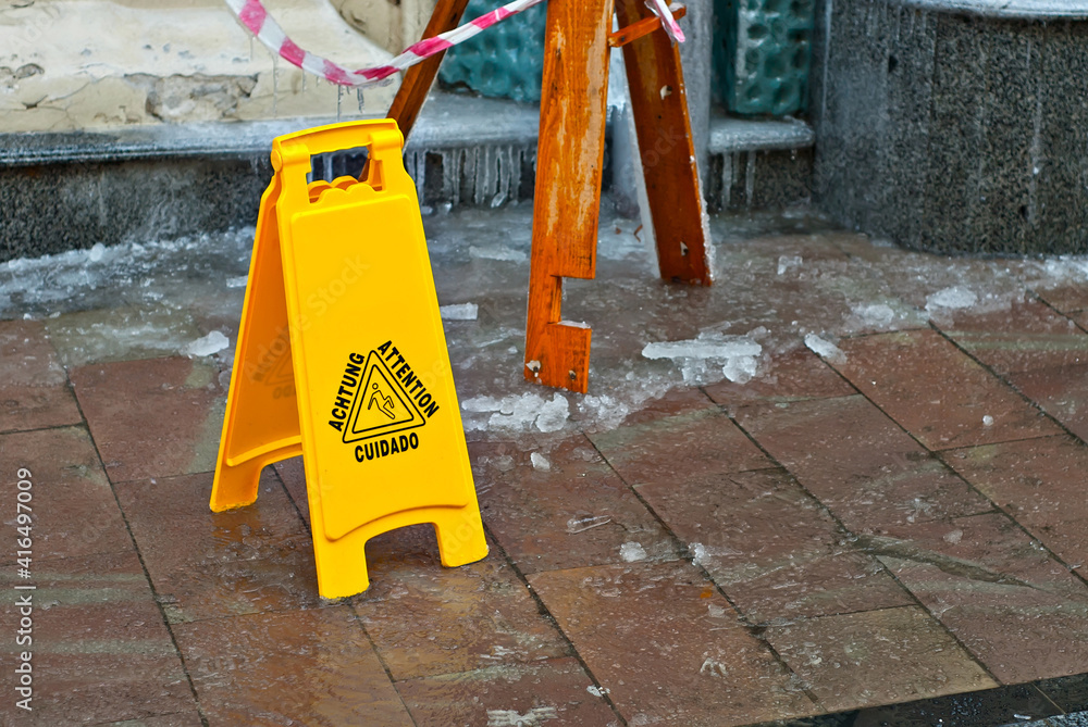custom made wallpaper toronto digitalYellow danger sign. Snow and ice on a slippery sidewalk. Inscription attention in different languages. Plate near the cobblestones in the spring.