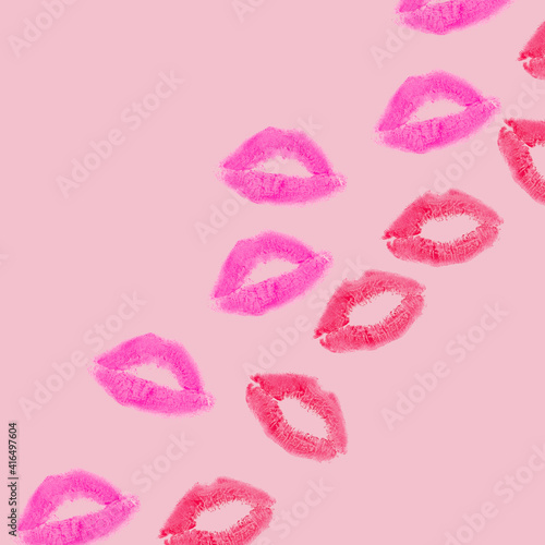 Creative pattern made with purple and red kisses on pastel pink background. Retro style aesthetic. Romantic concept with kiss print and lipstick. Makeup idea.
