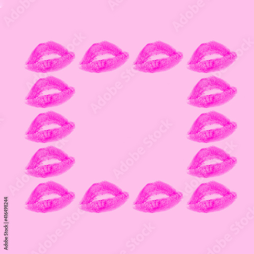 Creative frame made with purple or violet kisses on pastel pink background. Retro style aesthetic. 80s  90s Romantic concept with kiss print and lipstick. Valentines day idea.