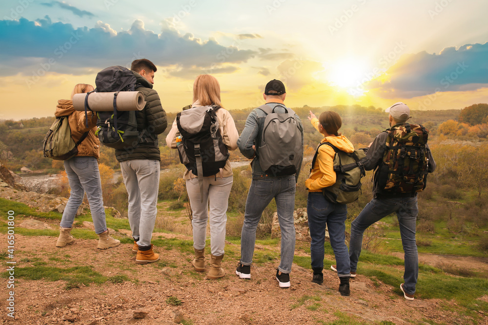 Fototapeta premium Group of hikers with backpacks in mountains, back view