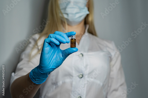 Nurse holds medical vial or ampoule. Vaccine. The ampoule with the medicine.