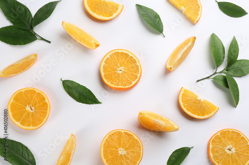 Slices of delicious oranges on white background, flat lay