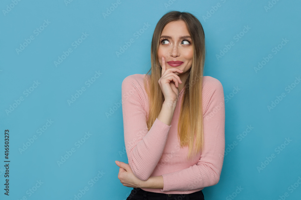 Cute Young Woman Is Holding Hand On Chin And Looking Aside. Cute Young Woman Is Holding Hand On Chin And Looking Aside.