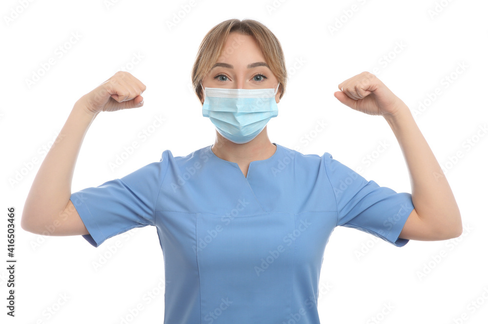Doctor with protective mask showing muscles on white background. Strong immunity concept Doctor with protective mask showing muscles on white background. Strong immunity concept