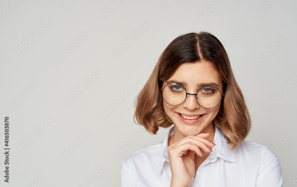 Beautiful woman wearing glasses short hair white shirt and beige background Beautiful woman wearing glasses short hair white shirt and beige background