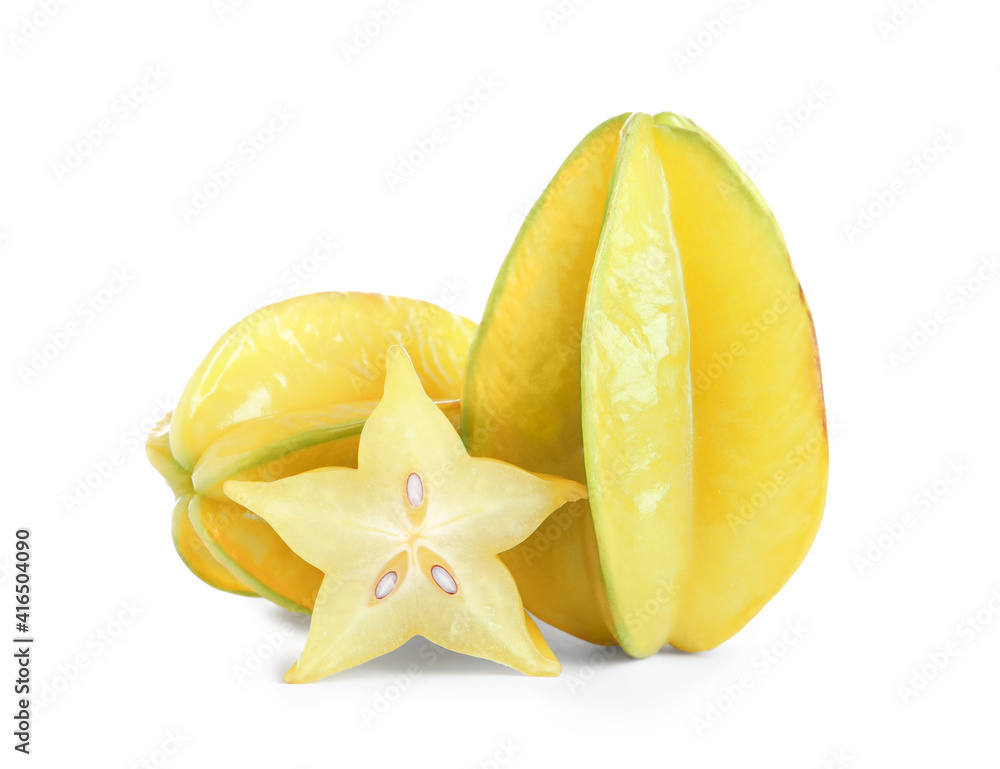Cut and whole carambolas on white background