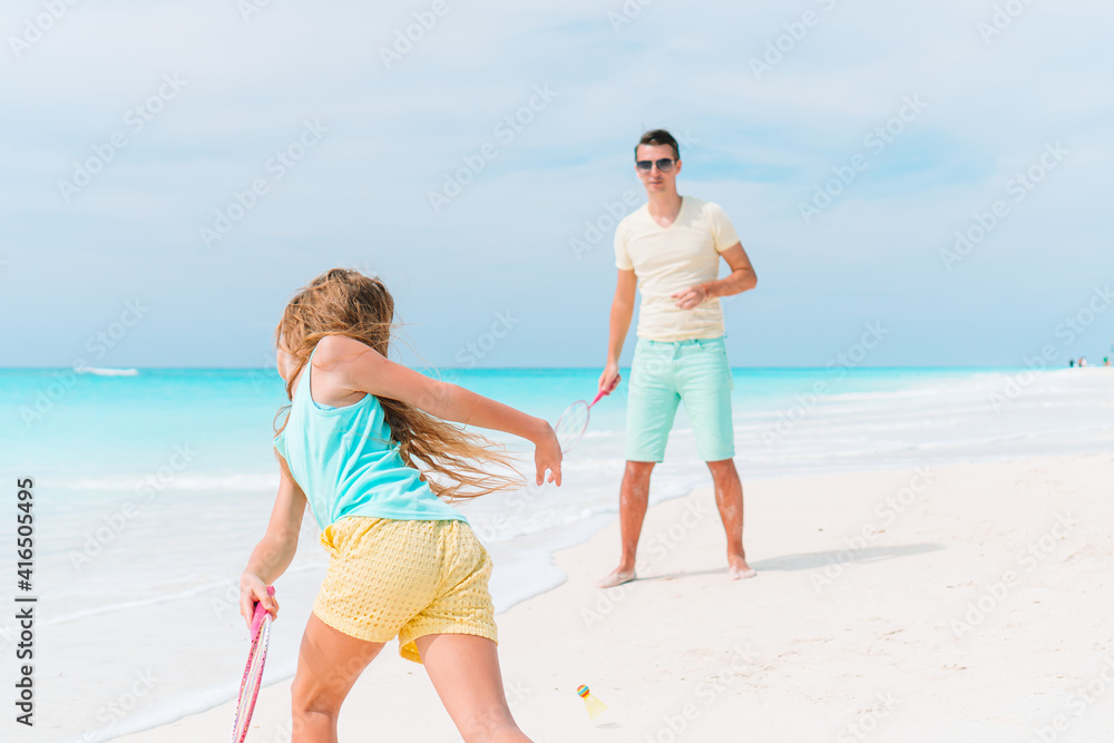 Little girl and happy dad having fun during beach vacation Little girl and happy dad having fun during beach vacation
