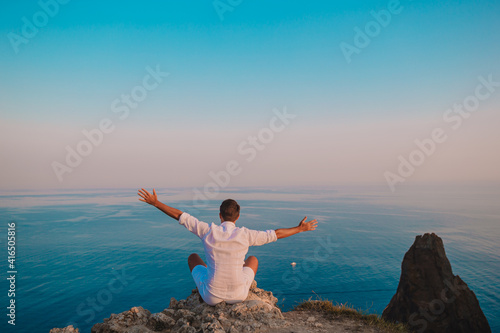 Man outdoor on edge of cliff seashore