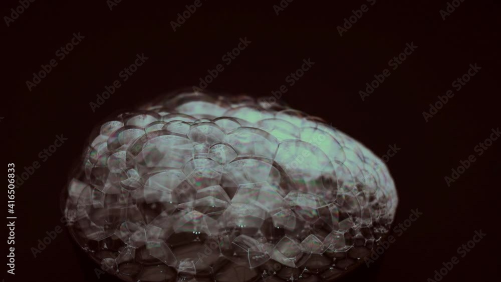Bubbles of soap foam, close-up, abstract colors, on a black background, macro photography Bubbles of soap foam, close-up, abstract colors, on a black background, macro photography