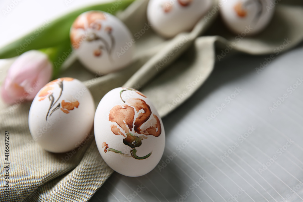 Beautifully painted Easter eggs on plate, closeup. Space for text