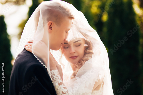 newlyweds walk in a beautiful park